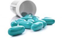 [blue capsules spilling out of a bottle]
